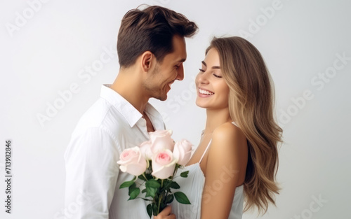 beautiful young couple in love girl model with a young man with a bouquet of flowers, international women's day, warm relationship care and attention, selective