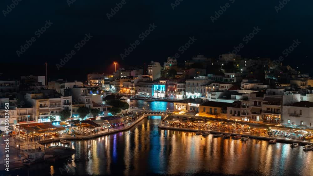Panoramic view of Agios Nikolaos city in Crete Greece, Timelapse at night with blue sky and scenic clouds Panoramic view of Agios Nikolaos city in Crete Greece, Timelapse at night with blue sky and scenic clouds