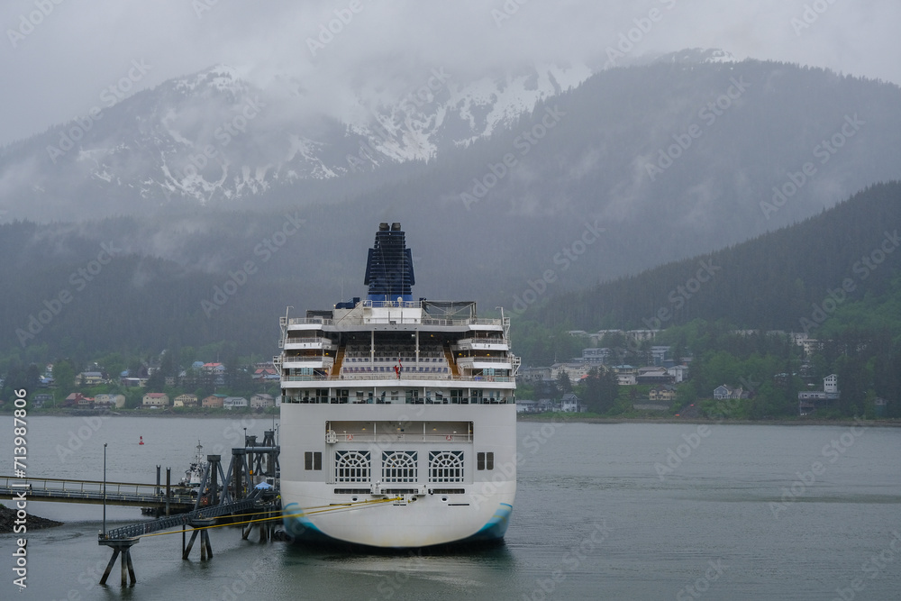Modern family cruiseship cruise ship liner Spirit docked in Juneau,  Alaska with panoramic nature scenic coast views on misty foggy grey day