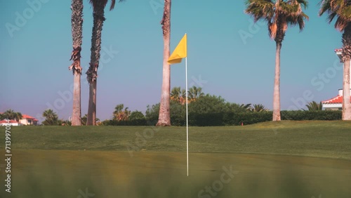 Golf course flag, summer tropical golf resort, green hole tee links course photo