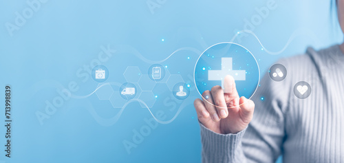 Woman hand touching plus with healthcare medical icon on blue sky background. Health insurance health concept. Access to welfare health and copy space, benefit pharmacy, plan community treatment.