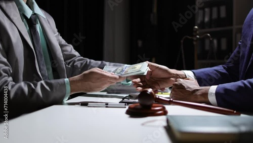 Corrupt lawyer accepts bribes from an unknown man in the dark. Businessman in the dark tries to bribe officials. photo
