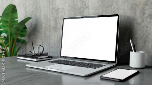 Close up of empty white laptop computer and smartphone on gray desk. Concrete wall background. Device presentation and online education concept. Mock up, 3D Rendering      