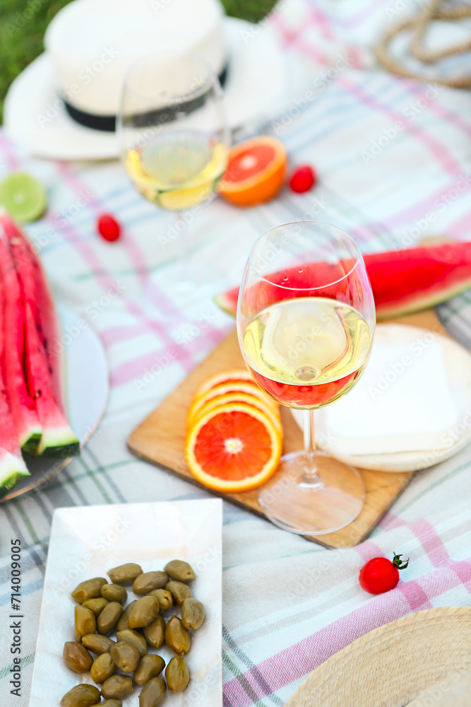 Picnic with white wine on green grass Picnic with white wine on green grass