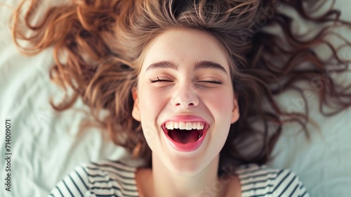 expressive young woman lying down open mouth happy girl enjoying life close up     photo