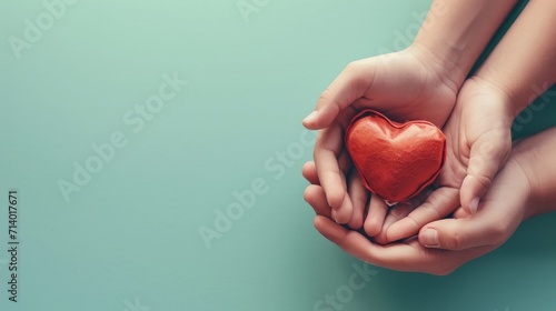 adult and child hands holding red heart on aqua background, heart health, donation, CSR concept, world heart day, world health day, family day  #714017671