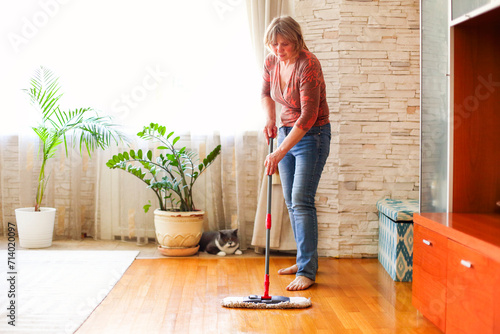 Adult lady cleaning floor at home photo