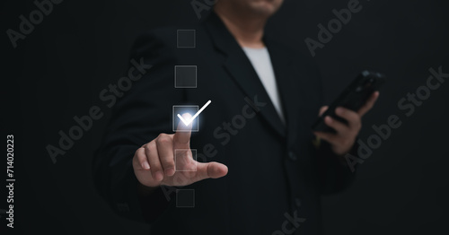 Performance checklist concept : businessman using finger with mobile phone for questionnaire, evaluation, assessment online or survey exam and filling out for digital survey and checklist
