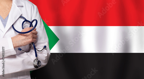 Sudanese medicine and healthcare concept. Doctor close up against flag of Sudan background photo