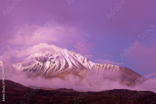 Snowy mountain details with clouds in Lauca National Park in northern Chile at sunrise photo