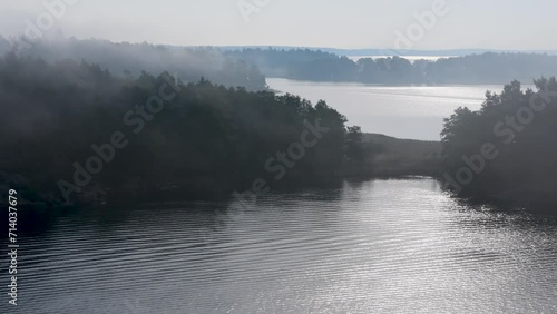Island formation in peaceful and still sea water on a foggy morning,  Archipelago, Sweden, nearby Stockholm.