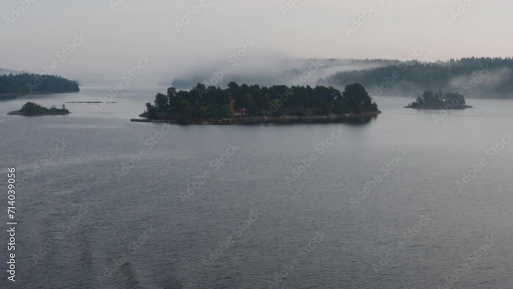 Island formation in peaceful and still sea water on a foggy morning, Archipelago, Sweden, nearby Stockholm. Island formation in peaceful and still sea water on a foggy morning, Archipelago, Sweden, nearby Stockholm.
