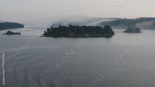Island formation in peaceful and still sea water on a foggy morning,  Archipelago, Sweden, nearby Stockholm.