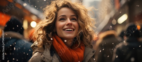 A winter girl exudes joy as she smiles on the chilly street, her hair dancing in the wind while bundled up in a cozy jacket