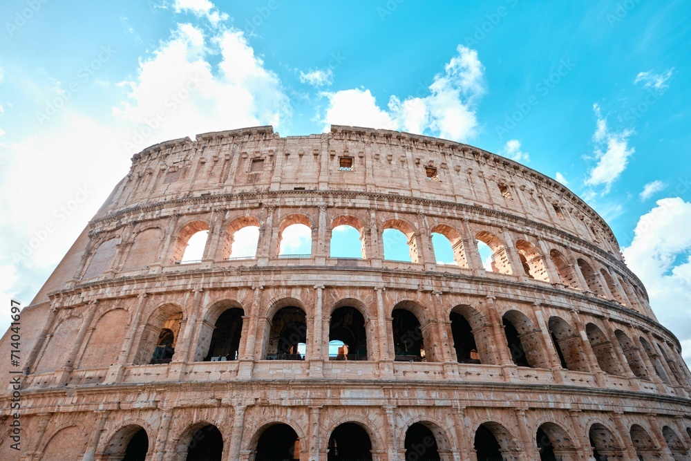 The Colosseum, Architectural wonder of Roman Empire (Colosseo) with blue sky background and clouds, Rome, Italy