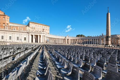 St. Peter's Basilica colonnade with rows of chairs on piazza San Pietro, Rome, Italy