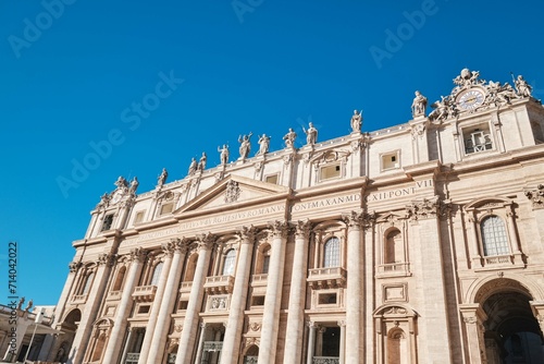 View of Saint Peter's Basilica and it's facade detail with Corinthian order columns and blue sky, Rome, Italy