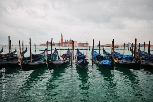 Traditional gondolas with the bell tower of the Saint Giorgio Maggiore Church on background (view from San Marco), Venice, Italy © BERK OZDEMIR
