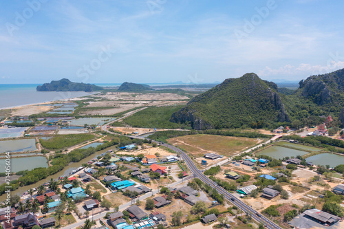 Aerial top view of residential local houses with Phasi Charoen, Chao Phraya canal or river, nature trees, Nonthaburi City, Thailand in urban city town in Asia, buildings. photo