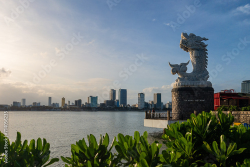 dragon carp statue and the skyline of danang in vietnam photo