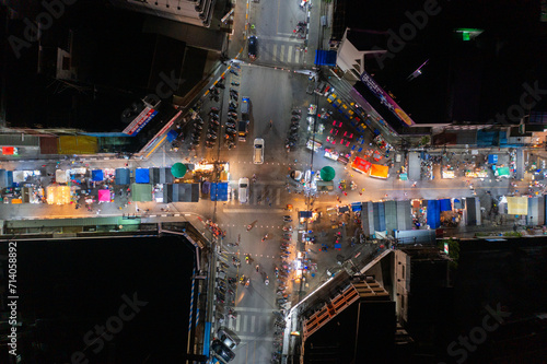 Aerial top view of night temple fair, and night local markets. People walking street, Colorful tents in Bangkok city, Thailand. Retail shops