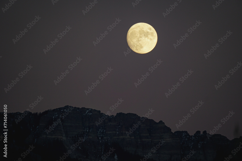 Golden moonrise over mountains at dusk Golden moonrise over mountains at dusk