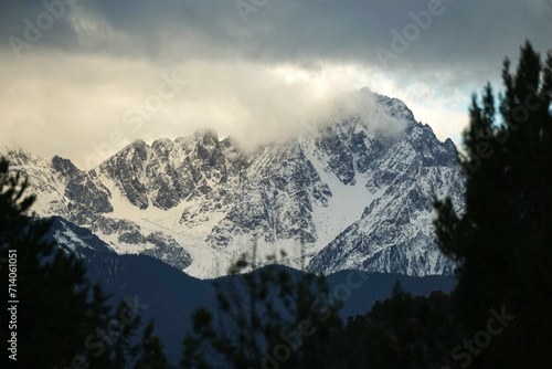 Cloudy, moody sunrise over snowy mountains in the Colorado Rocky Mountains
