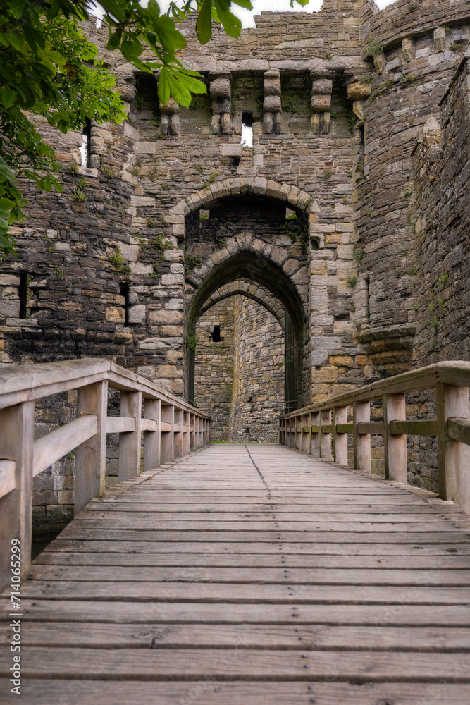 Bridge to the gatehouse and portcullis of an old stone medieval castle - Beaumaris Castle, Anglesey North Wales