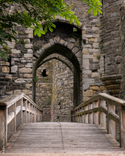 Bridge to the gatehouse and portcullis of an old stone medieval castle - Beaumaris Castle, Anglesey North Wales photo