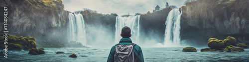 Traveler looking at view and stand in front of A picturesque waterfall, where cascading waters create a soothing melody