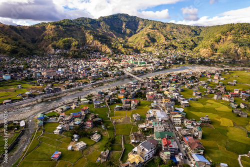 Aerial of the town of Bontoc, the capital of the landlocked province of Mountain Province, in the Cordillera Region of the Philippines. A valley town with terraced rice fields and residential areas.