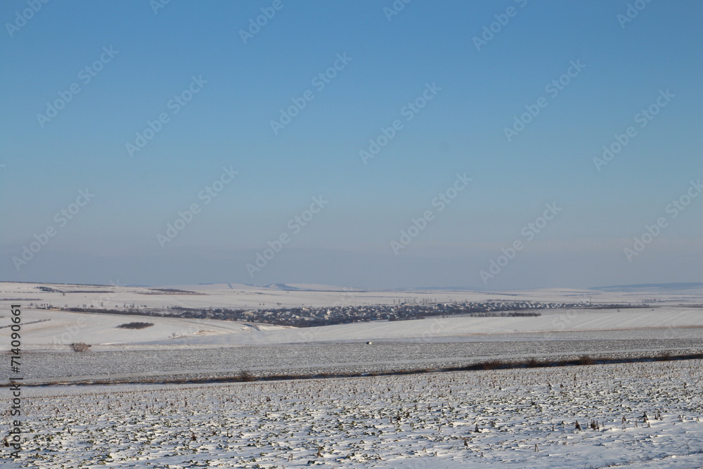 A snowy landscape with a power line