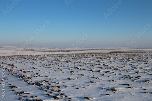 A snowy landscape with a blue sky