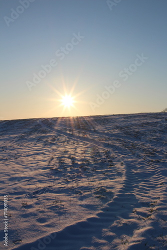 A snowy landscape with a bright sun
