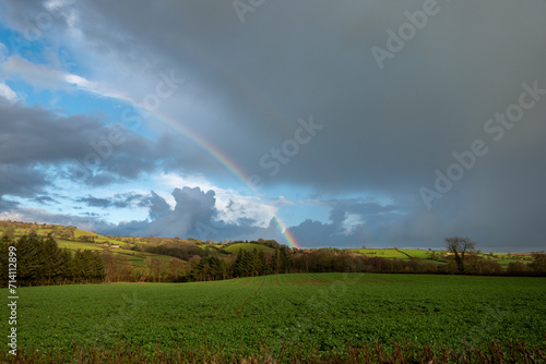 rainbow over field in rural England