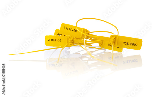 Yellow plastic security seals on a white background photo