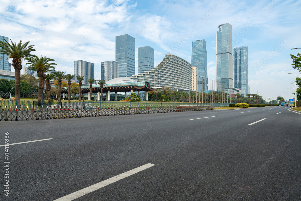 Car background, empty roads and skyscrapers in the financial district, Xiamen, China Car background, empty roads and skyscrapers in the financial district, Xiamen, China