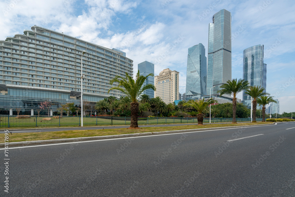 Car background, empty roads and skyscrapers in the financial district, Xiamen, China Car background, empty roads and skyscrapers in the financial district, Xiamen, China