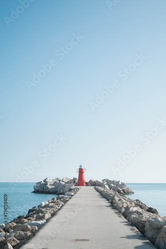 Red lighthouse against sky