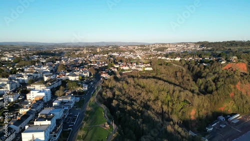 Babbacombe, Torbay, South Devon, England: AERIAL VIEWS: Babbacombe Downs, Hotels, Oddicombe beach and St Marychurch in the dawn sunlight of a winter's day (Clip 3). photo