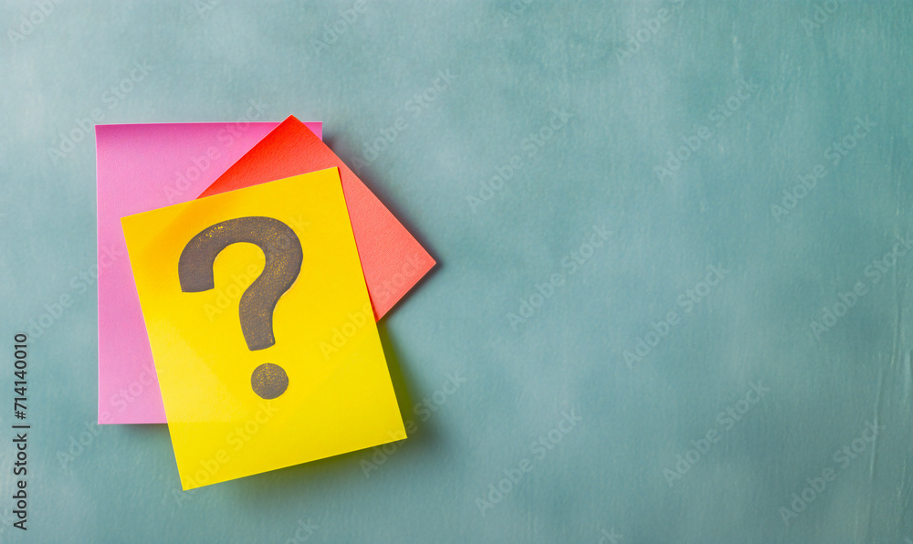 Question on a sheet of notepad on a background with space for text. Question on a sheet of notepad on a background with space for text.