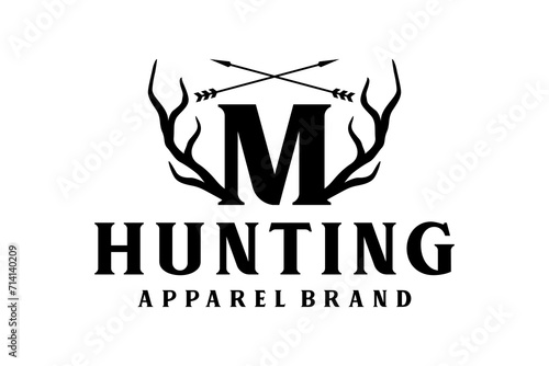 Outdoor hunting logo design, with elements of deer antlers and arrows on the initial letter M. photo