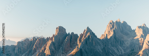 Canvas-taulu mountain ridge in the dolomites at sunrise with a blue sky