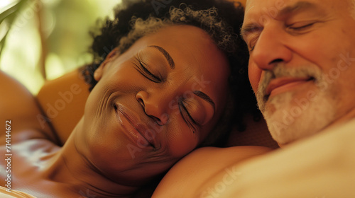 Happy interracial senior couple embracing and napping, retired mixed marriage, ai generated