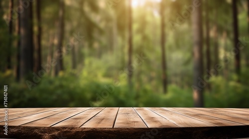 Empty wooden table for product display montage with nature green forest background