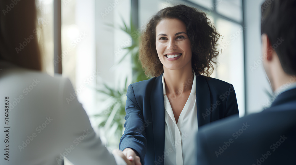 Happy Mid-Aged Business Woman Manager Handshaking at Office Meeting Happy Mid-Aged Business Woman Manager Handshaking at Office Meeting