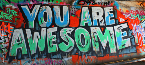 Graffiti wall background with text message YOU ARE AWESOME and paint splashes