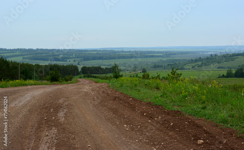 empty gravel road going down the hill copy space