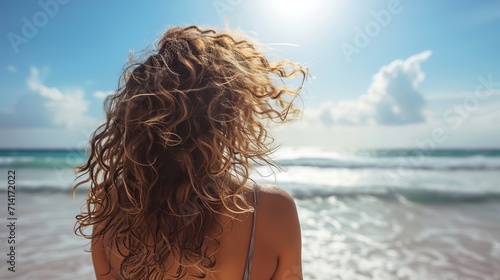 Woman Standing on Beach, Enjoying the Sun and Sand