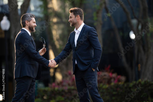 Businessman handshake for teamwork ,successful. Business network concept. Management strategy. Human resources. businessman greeting and making handshake with a businessman outdoors in city walkway.